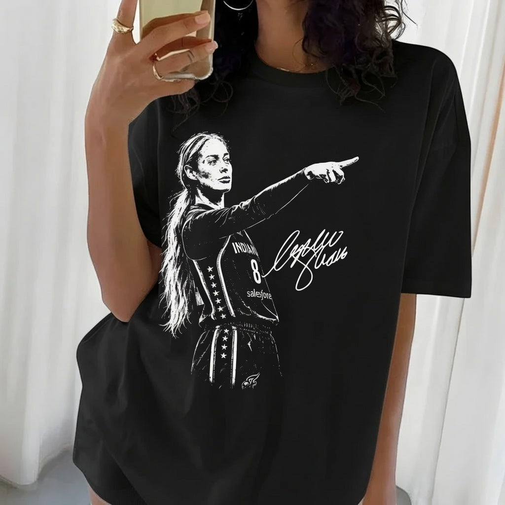 TrendyShift.Com black cotton t-shirt featuring a white graphic of a female basketball player pointing with a signature