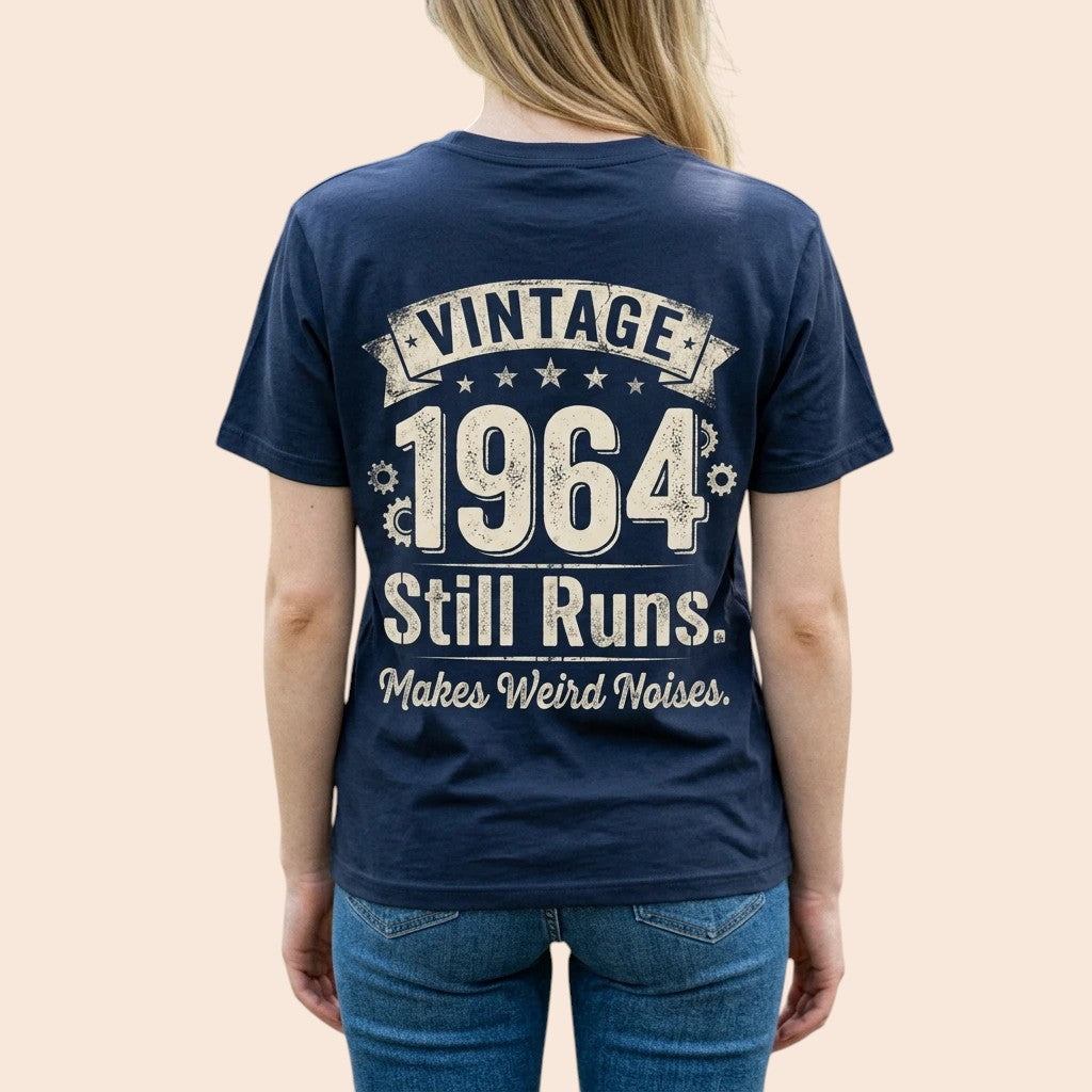 TrendyShift.Com navy blue 100% cotton t-shirt with Vintage 1964 Still Runs Makes Weird Noises graphic on the back